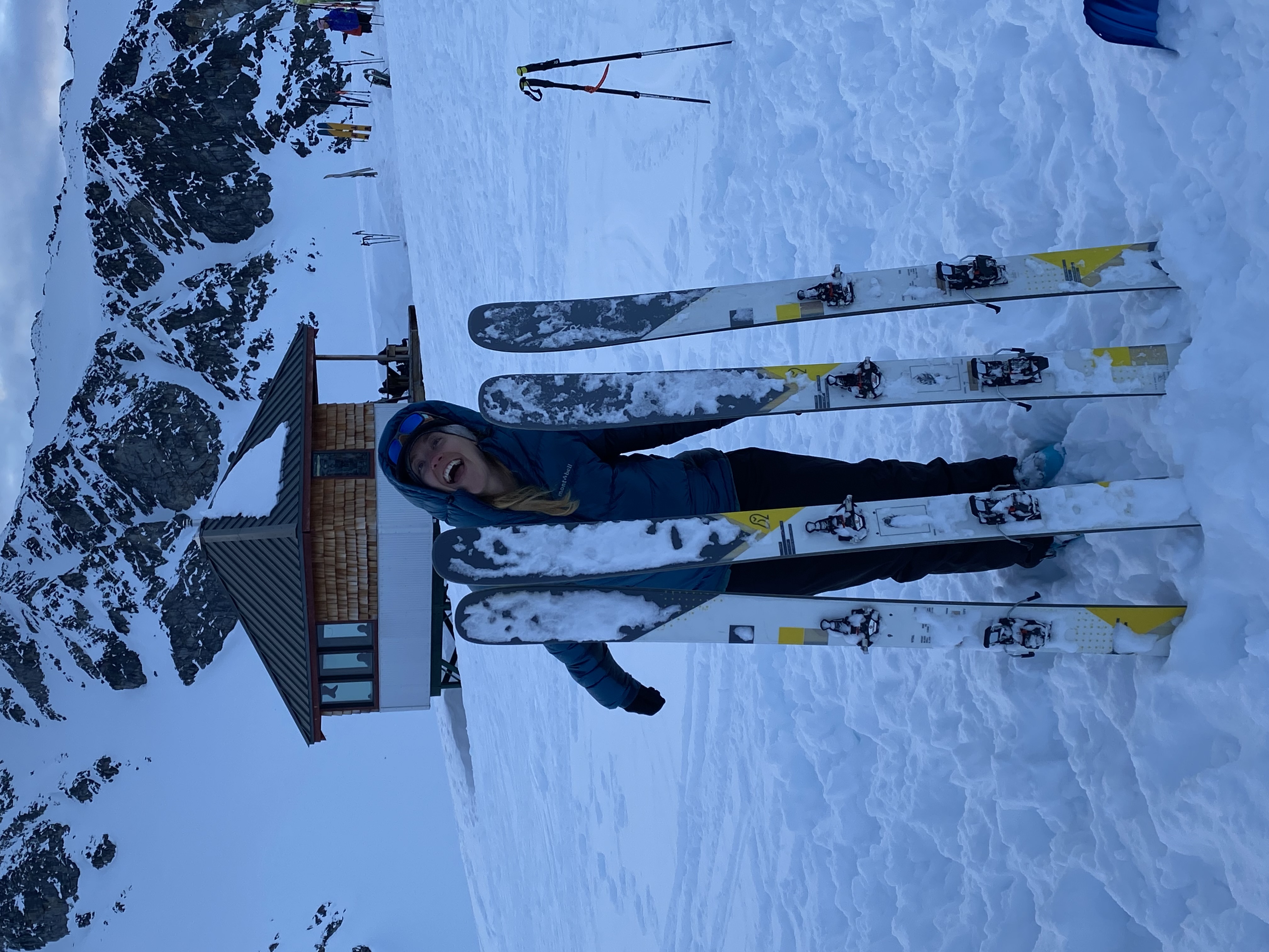 Karly with WNDR Vital skis at Snowbird Hut in Alaska